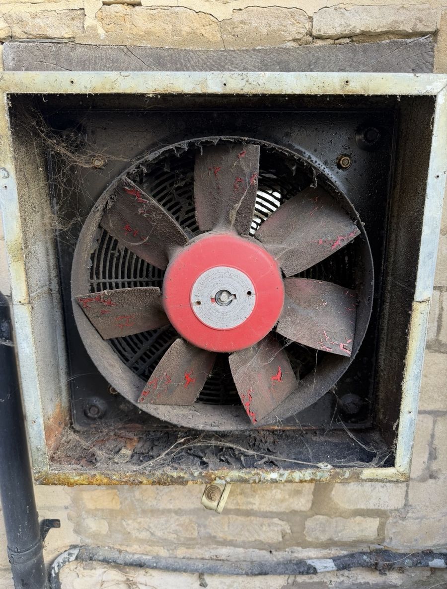 Old kitchen wall extraction fan clogged with grease and dirt